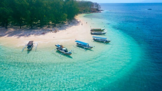 Image of tourist ships anchored on the Gili Rengit beach at Lombok Indonesia